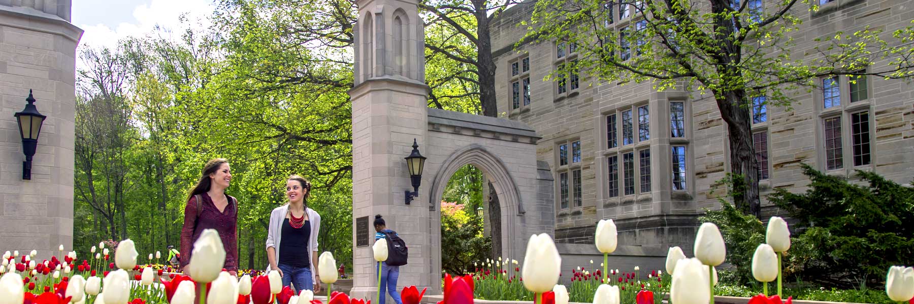 Students walk through the main gates of campus